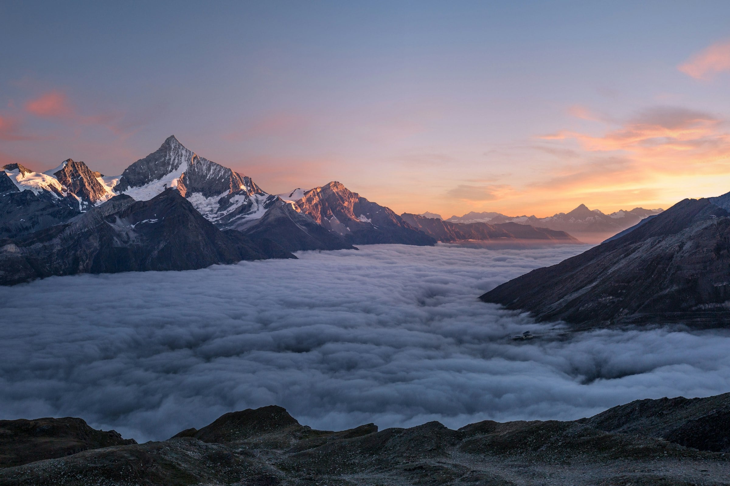 Alpine peaks above a sea of cloud at dawn