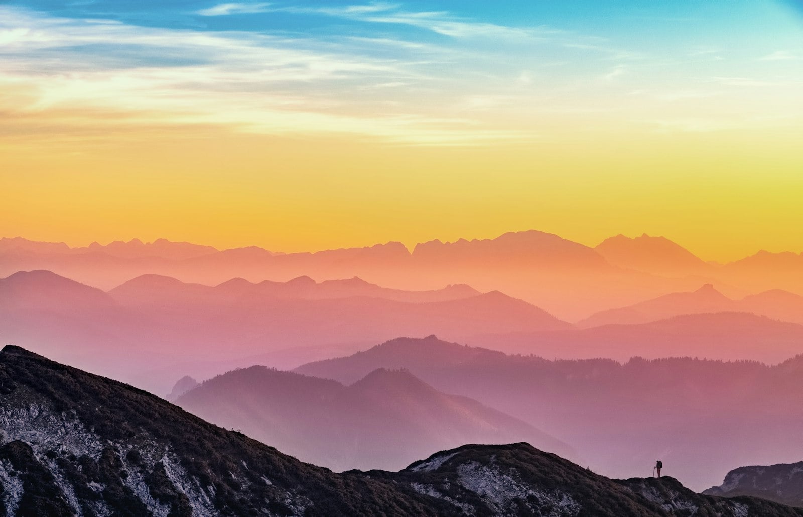 Layered mountain ridges glowing at sunset